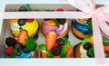 Cupcakes with berries in a gift box with a bow. Royalty Free Stock Photo