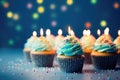 Cupcakes with blue buttercream frosting and burning candles on blue background, Birthday cupcake with candle on wooden table with