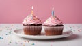 cupcakes with candles A birthday cupcake with a lit candle and colorful sprinkles on a white plate. Royalty Free Stock Photo