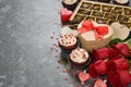 Cupcakes, chocolate and rose on a gray background