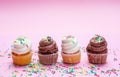 Cupcakes with colorful sprinkles on pink background, copy space Royalty Free Stock Photo