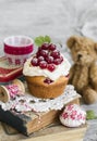 Cupcakes with cottage cheese cream and red currants and toy bear