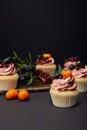 Cupcakes with cream, fruits and berries