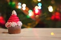 Cupcakes decorated as Santa`s hat, for christmas, against colorf