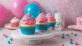 cupcakes with frosting and sprinkles Birthday cupcakes with pink and blue frosting and sprinkles on a white cake stand.