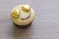 A cupcakes with heart shape chocolate on wooden table Royalty Free Stock Photo