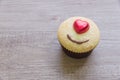 A cupcakes with heart shape chocolate on wooden table Royalty Free Stock Photo