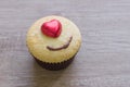 A cupcakes with heart shape chocolate on wooden table Royalty Free Stock Photo