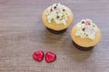 A cupcakes with heart shape chocolate on wooden table