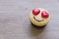 A cupcakes with heart shape chocolate on wooden table