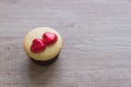 A cupcakes with heart shape chocolate on wooden table Royalty Free Stock Photo