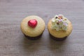 A cupcakes with heart shape chocolate on wooden table Royalty Free Stock Photo