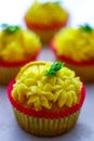 Cupcakes with a lemon cupcake at the front, shallow focus, focus on lemon buttercream. Royalty Free Stock Photo