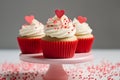 Cupcakes with red heart and sprinkle decoration on frosting on cake stand