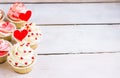 Cupcakes with red hearts for St. Valentines Day.White wooden background.