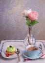 Cupcakes on a table with a cup of coffee and a vase of roses Royalty Free Stock Photo