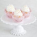 Cupcakes with vanilla cream on cake stand Royalty Free Stock Photo