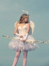 Cupid cute angel with bow and arrows. little Cupid girl aiming at someone with an arrow of love. Angel child girl with