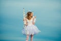 Cupid cute angel with bow and arrows. Pretty white little girl as the cupid with a bow and arrow congratulating on St Royalty Free Stock Photo