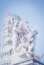 Cupid statue and the Leaning Tower of Pisa in Piazza dei Miracoli