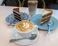 Cuppacino coffee with cakes on the table for tea time Royalty Free Stock Photo