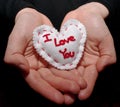 Cupped hands holding a single white heart Royalty Free Stock Photo