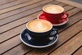 Cups of aromatic coffee on wooden table Royalty Free Stock Photo