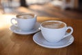 Cups of aromatic coffee on wooden table in cafe, closeup Royalty Free Stock Photo