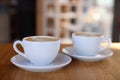 Cups of aromatic coffee on wooden table in cafe, closeup Royalty Free Stock Photo