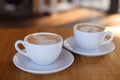 Cups of aromatic coffee on wooden table in cafe, closeup Royalty Free Stock Photo