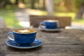 Cups of cappuccino with latte art on wooden table outdoor coffee shop Royalty Free Stock Photo