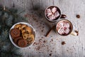 Cups of cocoa with marshmallows and chocolate cookies on a table background. Christmas sweets. Cafe breakfast. Royalty Free Stock Photo