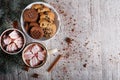 Cups of cocoa with marshmallows and chocolate cookies on a table background. Christmas sweets. Cafe breakfast. Royalty Free Stock Photo