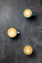3 cups of coffee on grey background top view. Cappuccino Latte and Flat White