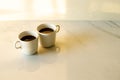 Cups of coffees on white marble table in morning light Royalty Free Stock Photo