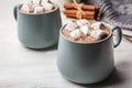 Cups of delicious hot cocoa with marshmallows on table Royalty Free Stock Photo