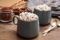 Cups of delicious hot cocoa with marshmallows on table Royalty Free Stock Photo