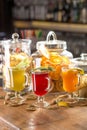 Cups with different hot winter tea with lemon, rosemary and celery on wooden bar counter Royalty Free Stock Photo