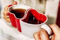 Cups in the form of hearts in the hands of a man and a woman Royalty Free Stock Photo