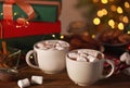 Cups of hot cocoa drink with marshmallows on wooden table Royalty Free Stock Photo