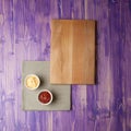 Cups with ketchup and cheese on napkin made from canvas on a wooden table