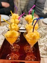 Cups of oranger sorbetto with multicolored straw