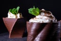 Cups printed on a 3D printer with chocolate, whipped cream and mint leaves