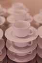 Cups and saucers standing on top of each other . Breakfast at hotel. Coffee bar. Lunch at restaurant. Preparation for