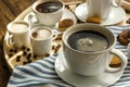 Cups with tasty aromatic coffee and cookies on tray