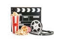 Cups with tasty popcorn, film reel and clapperboard on white background