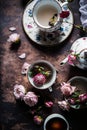 Cups of tea and beautiful flowers. Refined vintage dishes. Generative Ai