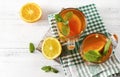 cups of tea with orange and mint, slices of fresh orange on a towel on a white background Royalty Free Stock Photo
