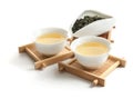 Cups of Tie Guan Yin oolong and chahe with tea leaves