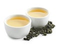 Cups of Tie Guan Yin oolong and tea leaves Royalty Free Stock Photo